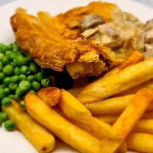 Pub Style Chicken and Mushroom Pie served with chips and peas