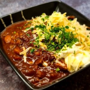 Slow cooker chilli with rice, cheddar cheese and sour cream