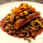 Butchers Sausage over braised lentils and buttered cabbage, with caramlised onions